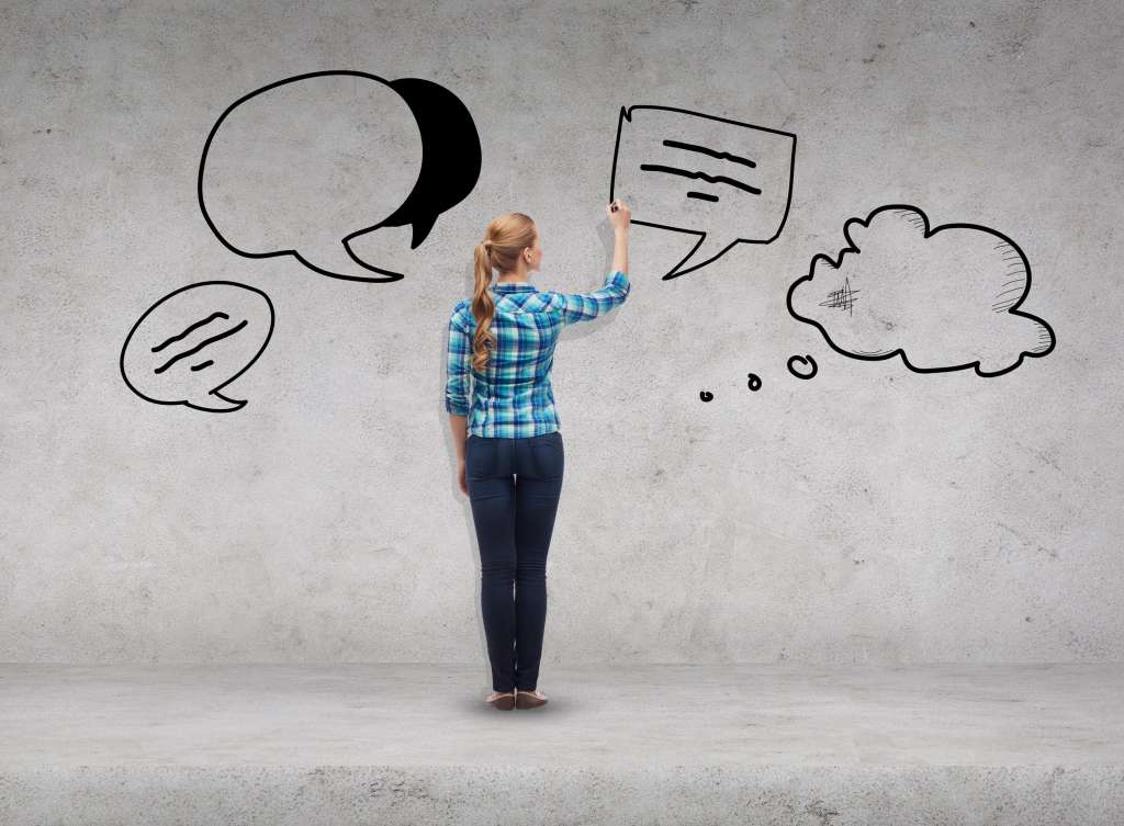 happiness and people concept - smiling young woman writing or drawing text bubbles on virtual screen