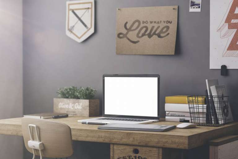 Stylish workspace with computer and posters on home or studio